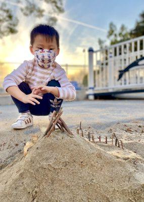 Playing with sand and sticks