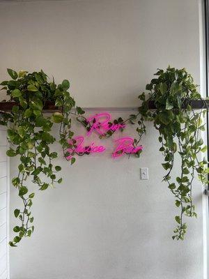 Ruby neon pink sign entangled with pothos that I love so much.