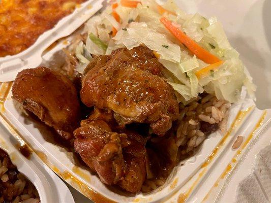 Stew Chicken over rice and peas with a side of cabbage