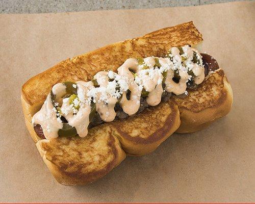 OLD TOWN - smoked bacon wrapped dog, caramelized onions, chipotle aioli, pickled jalape-os, cotija cheese