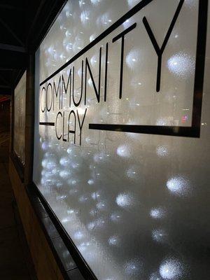 Front window showing Community Clay sign