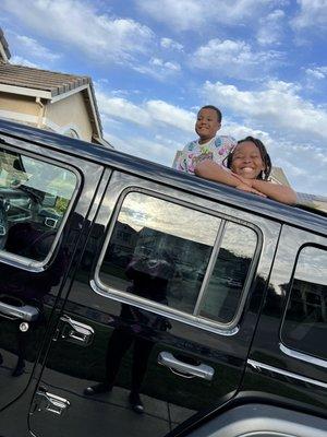 Happy kids enjoying their new Jeep Wrangler