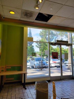 Leaking and open ceiling panel inside the store