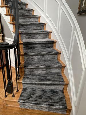 Beautiful carpet runner on curved steps.