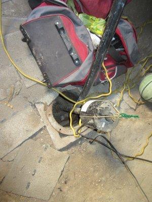 Six things (let's call them opportunities) were wrong   with the installation of this sump and pump. Can you spot two in this photo?