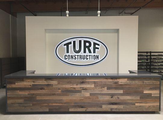 Interior office sign for Turf Construction in Camarillo.  Reverse channel letters "halo" lighting.