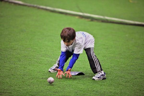 Baseball Class at Unlimited Sports Action! One of our younger players learning proper fielding techniques.