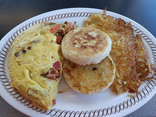 Tomato and onion omelet, grilled biscuit, and hash browns. Yum!