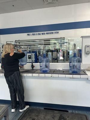 Filling water bottles for Barefoot and Free Yoga Festival, at Proud Lake Recreation Park.