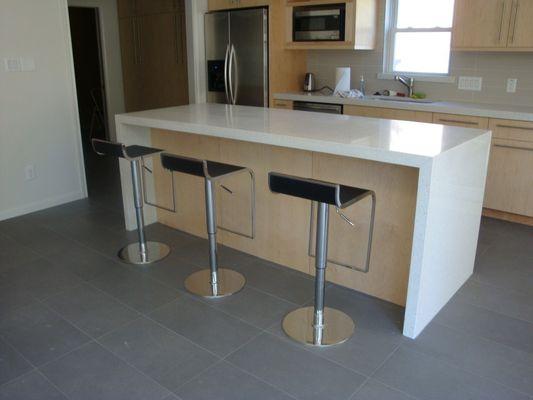 Quartz island with mitered waterfall panels