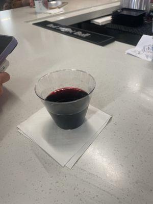 Glass of $26 wine served in a plastic cup