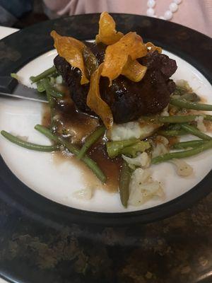 Filet Mignon over french style green beans and whipped potatoes.  Garnished with a sweet potato.