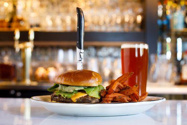 The Chalkboard Burger - bacon + onion marmalade, aged sharp cheddar, arugula, brioche bun, house fries