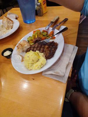 12 Oz ribeye steak with house salad, mashed potatoes  &  veggies, $31.99.