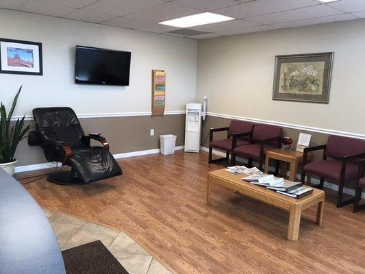 Waiting room with massage chair and drinking water