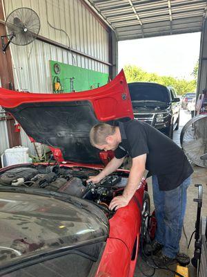 Cody diagnosing a Corvette.  After it's repaired, it needs to be washed!