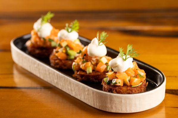 King Salmon Tartare on crispy potato latkes with lemon, cucumber, creme fraiche, dill