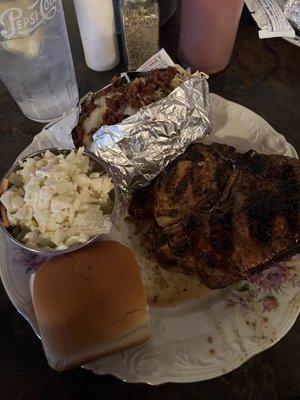 Grilled pork chop, baked potato, coleslaw