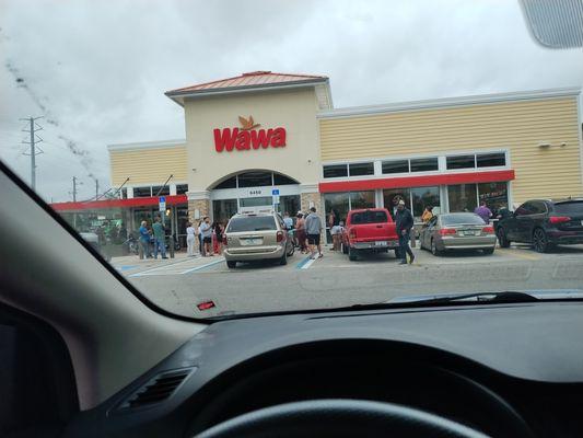 People arriving And waiting on the store to open