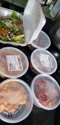 Poke taste testing.  Off Da Hook in Styrofoam container and da Hawaiian ahi in back