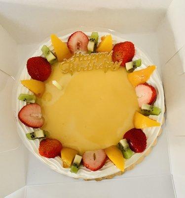 Taro pudding cake. Vanilla based cake, taro layer in the middle, pudding on top with fruit.