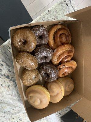 Dozen donuts. Blueberry and chocolate cake donuts. Maple cinnamon glazed, and cinnamon apple roll donuts. All delicious!