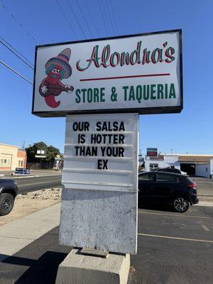 Alondra's Store and Taqueria sign that says "Our salsa is hotter than your ex"