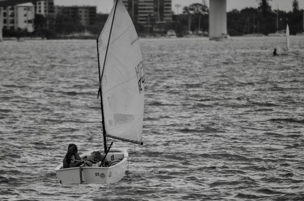 Youth sailor in an Opti class boat