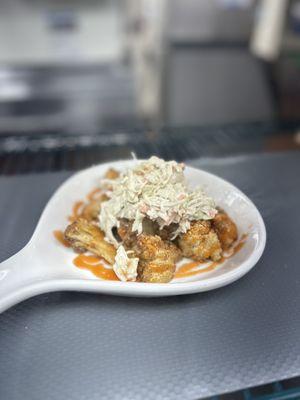 Flash fried cauliflower with honey hot sauce and house made tangy coleslaw