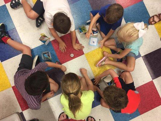 Progress in therapy and learning takes place where the child is comfortable.  That can be at a table, in a chair, or playing on the floor!