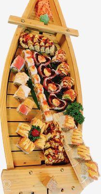 Several kinds of sushi rolls together in a boat ！Yummm......