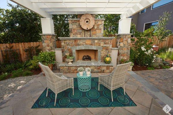 Outdoor fireplace and custom paver patio design.