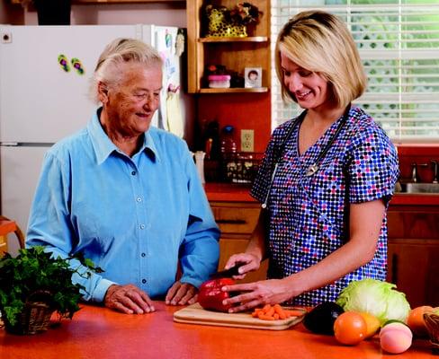 Caregiver and client preparing meal