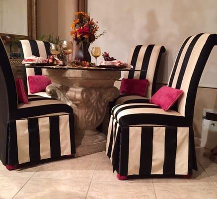 Custom upholstered dining room chairs with pillows and matching socks.