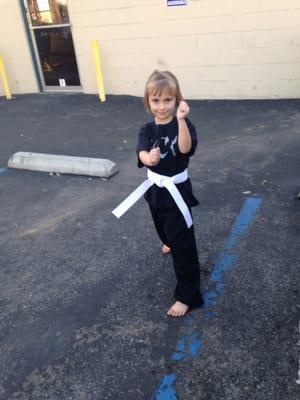 Just earned her first belt and is so proud of herself.