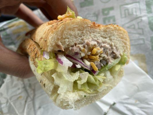 Tuna on Italian herb and cheese bread lettuce, peppers,  pickles and onions