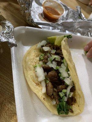 Steak taco with cilantro and onion