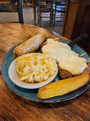 Country fried steak with corn on the cob and mac and cheese