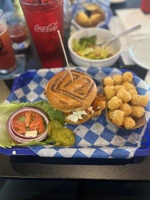 Honey Habanero Crispy Chicken topped with slaw and a side of tots