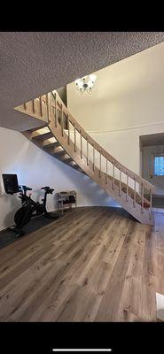 New flooring and freshly sanded/stained floating curved staircase.