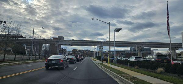 1/12/24 behind me is the Tesla Car Dealership.  I  front if me is Wal-Mart off in the distance.