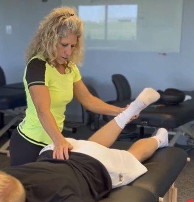 Jen treating a client utilizing Muscle Activation Techniques