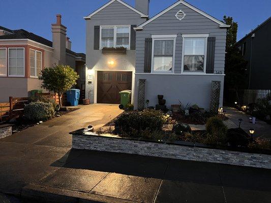 Stacked stone veneer on retaining wall in front