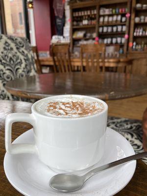 Irish coffee with a dusting of cocoa powder.