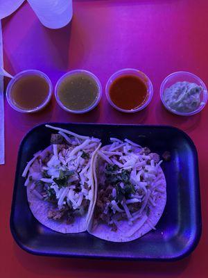 2 chicken tacos with cheese, onion and cilantro. 4 dipping sauces from the salsa bar