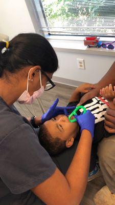 Showing one of our favorite patients, and his mom, how to keep mouths healthy at home.