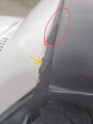 Sticky foam partially stuck to windshield header seal, Black sealant (?) slopped on, not cleaned up, smeared down a-pillars also.