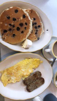 Blueberry pancakes, scrambled eggs with cheese and sausage links