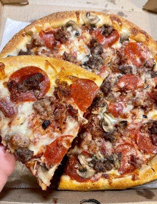 Masterpiece Pizza - pepperoni, mushrooms, bacon, hamburger, sausage - showing a slice