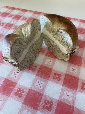 Spinach bagel with cream cheese.